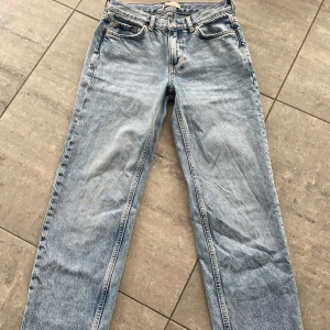 Ljusblå raka jeans  - Klassiska ljusblå jeans  med raka ben och fem fickor. Jeansen har rak passform och knappgylf. Perfekta för en avslappnad stil och funkar året runt.