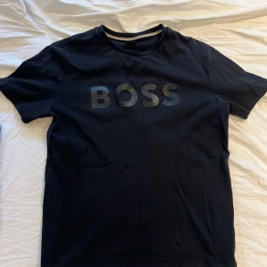 Klädpaket märkes t shirtar - Här är ett klädpaket med t-shirts och shorts från märkena BOSS och Moncler. I paketet ingår t-shirts i färgerna svart, grön och ljusblå, samt ett par blå shorts och en blå pikétröja. Allt är 100% äkta. Passformen är bra för en som är en liten L och en stor M. Lite små i storlekarna. Men ursprungs storleken är L på samtliga tröjor.