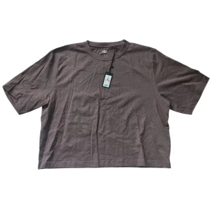 Brun boxy t-shirt från 157, XL - Boxy t-shirt i en brun nyans från Lager 157. Modellen är oversized med korta ärmar och rund halsringning. Tillverkad i mjuk bomull som känns skön mot huden. Perfekt för en chill och avslappnad look.