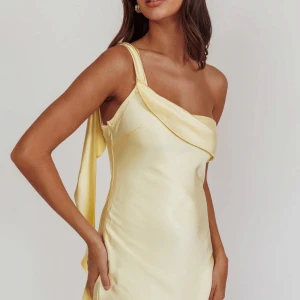 Ljusgul långklänning i satin med oneshoulder - Helt oanvänd jättefin satin klänning med lappen kvar. Strolek xs, skriv gärna för fler bilder eller info!