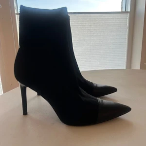 Svarta klackar  - Säljer ett par eleganta svarta stövletter med hög smal klack och spetsig tå. Skorna har en stilren design och är perfekta för att lyfta vilken outfit som helst. Passar dig som gillar en klassisk och trendig look.