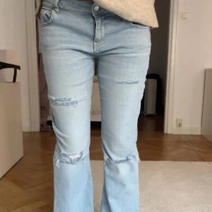 Ljusblå jeans med slitningar - Har inga mått eller fler bilder, jag är 172 och dom är 1 cm korta så dom passar perfekt på någon som är 170 ish!