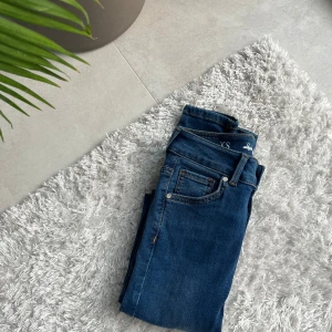 Blå skinny jeans med hög midja - Säljer ett par klassiska blå skinny jeans med hög midja. Har aldrig använts. Jeansen har fem fickor, bälteshällor och stängs med dragkedja och knapp. Perfekta till vardags och lätta att matcha med olika toppar. 🫶