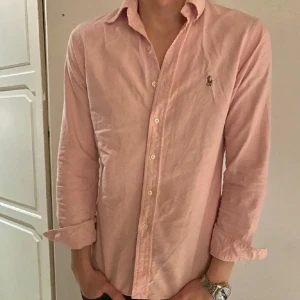 Rosa skjorta från Ralph Lauren - Säljer en stilren rosa skjorta från Ralph Lauren. Stroleken är S slim fit. Skjortan är i mycket fint skick 