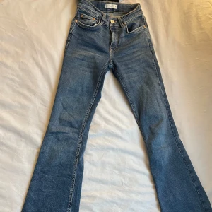 Blå bootcut jeans från Gina tricot - Snygga blå bootcut jeans från Perfect Jeans. De har en klassisk femficksdesign och en knappgylf. Perfekta för en avslappnad stil med en touch av retro. Passar bra till både sneakers och boots.