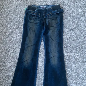 Lågmidjade jeans - Cilla lågmidjade jeans utan fickor med en snygg skärp detalj runt. Finns bild på men lite försmå på modellen. Midjemått: ca 38 cm, ytterbenslängden ca 98 cm.☺️bootcut