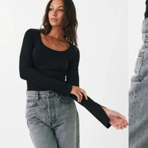Svart långärmad topp - Snygg oanvänd svart långärmad topp med slits vid ärmarna med rund halsringning. Perfekt för en stilren look och kan enkelt matchas med olika outfits. Storlek S men passar XS också