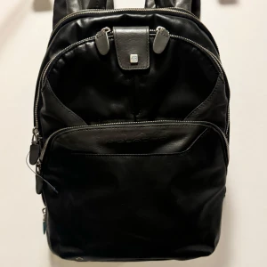 Piquadro laptop backpack  - Made of combination of real leather and other materials. 