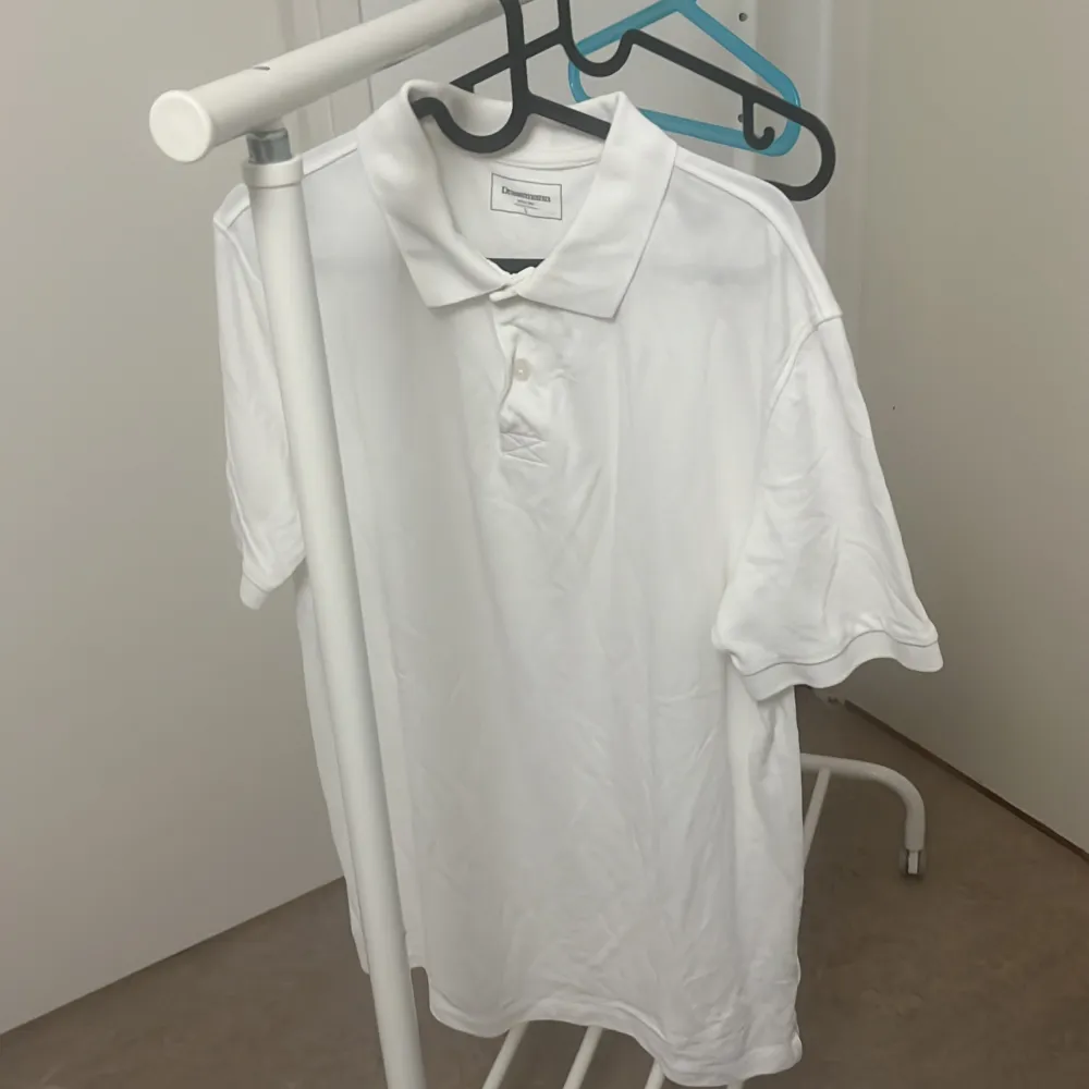 Säljer en klassisk vit pikétröja från Texet. Den är kortärmad och perfekt för sommaren. Tröjan har en krage och knappar framtill, vilket ger en stilren look. Materialet känns mjukt och bekvämt, perfekt för både vardag och lite mer uppklädda tillfällen.. T-paidat.