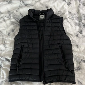 Svart dunväst från McKinley - Säljer en svart dunväst från McKinley i storlek 158/164. Som ny, säjet då den inte kommer till användning
