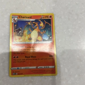 Charizard Pokémon-kort - Säljer ett Charizard Pokémon-kort med 170 HP. Kortet har en färgglad design med Charizard i en eldig pose. Perfekt för samlare eller Pokémon-entusiaster som vill stärka sin kortlek.