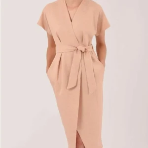 Beige omlottklänning med knytband - Elegant beige omlottklänning med knytband i midjan. Klänningen har korta ärmar och en stilren design som passar perfekt för olika tillfällen. Den mjuka färgen och det enkla snittet ger en sofistikerad look.