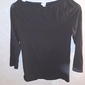 Svart och vit långärmad topp - Säljer två långärmade toppar i svart och vit med trekvarts ärm. Perfekta för vardagsbruk med en enkel och stilren design. De har en normal passform och är gjorda i ett mjukt material som känns skönt mot huden. Passar bra till både jeans och kjol! OBS! tröjan är inte fläckig🤍✨️