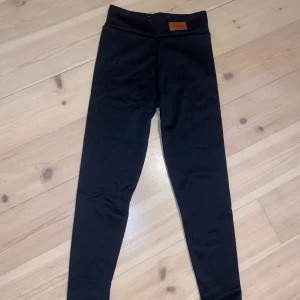Svarta leggings med fleecefoder - Säljer ett par svarta leggings från Fashion. De är fodrade med mjuk fleece, perfekt för kalla dagar. Leggingsen har en hög midja och är superbekväma. De är helt nya och kommer i originalförpackning. Perfekta för vintern! ❄️