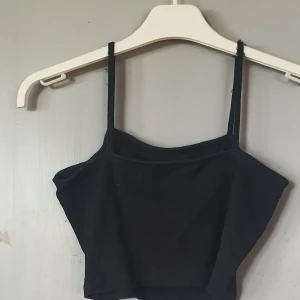 Svart ribbad linnetopp från Even&Odd - Säljer en svart ribbad linnetopp från Even&Odd. Toppen är ärmlös med smala axelband och har en tight passform. Perfekt för sommaren eller en festkväll! 🖤