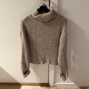 Beige ribbad polotröja - Säljer en mysig beige polotröja med ribbad struktur. Tröjan har långa ärmar och en hög krage.Perfekt för höst och vinter! Kommer från NAKD och använd ett fåtal gånger. Storlek S och nypris är 550, mitt pris 350💕