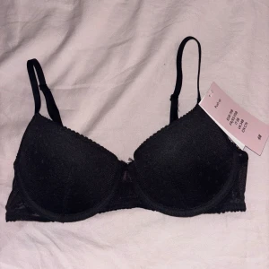 Svart bh från H&M - Helt oanvänd bh från h&m som jag beställde förra veckan men råkade köpa fel storlek prislappen sitter kvar. Den är en push up i stl 75B modellen är i mönstrat mesh tyg och med en halv cupa
