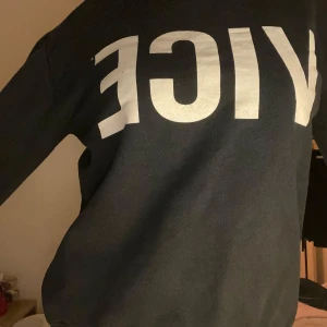 Svart sweatshirt med tryck - Säljer en svart sweatshirt med stort vitt tryck på framsidan. Tröjan har en avslappnad passform och är perfekt för en casual look. Passar bra till jeans eller joggers.