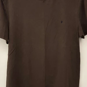 Brun t-shirt från Morris - Snygg brun t-shirt från Morris. Perfekt för en stilren och avslappnad look. Tröjan är i väldigt bra skick,  knappt använd. Tveka inte att fråga om du har några funderingar. 