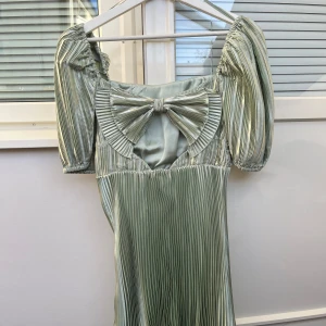 & Other Stories Sample klänning - Världens sötaste klänning! Den är i ett glansigt mintgrönt material!💓Den är helt unik!! Då det är en Sample och finns inte att köpa🤩💓 Den har en stor rosett baktill och en dragkedja på sidan💓 I superfint skick och nästan aldrig använd, har tyvärr ingen bild på, då den är för liten för mig😇💓