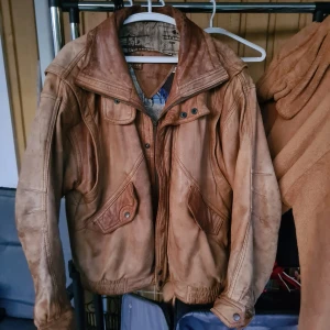 Jofama Läderjacka Vintage - En asfrän läderjacka som håller tätt och varmt. Troligtvis 80-tal! Har lite hål i fodret på insidan, mest känsligt vid armsluten, samt så saknar dragkedjan sin dragflik, men sånt är enkelt att fixa. Fin fin annars!