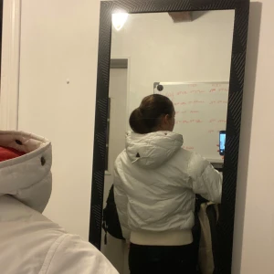 Vit vintage pufferjacka med rött på insidan. - Säljer en snygg vit pufferjacka med röd insida och huva. Jackan har en croppad passform och stängs med dragkedja. Perfekt för kyliga dagar! I storleken S/M