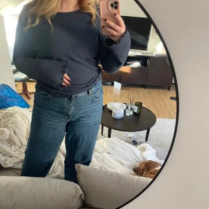 Mörkblå ribbad tröja - Säljer en mörkblå ribbad tröja med långa ärmar. Perfekt för en avslappnad stil och passar bra till jeans. Tröjan har jättefina vida ärmar vid handlederna, ångrar nästan att jag säljer den nu🥹