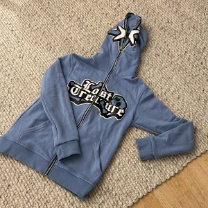 Lost Treasure hoodie   -  Skitsnygg y2k Hoodie med zip hela vägen upp genom luvan, inte riktigt min stil längre så jag säljer😂 