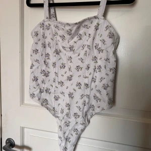 Body H&M - Blommig söt body från H&M i strl S. Trivs inte i body så därav har jag använt den någon enstaka gång. Supersöt till blå jeans🫐