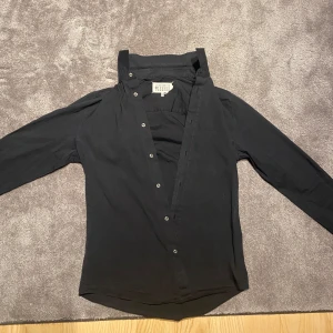Maison Martin Margiela Skjorta *ÄKTA* - Säljer denna sköna skjorta från margiela till ett billigt pris. Defekterna som förekommer syns på bilderna. Skriv om ni har några funderingar.