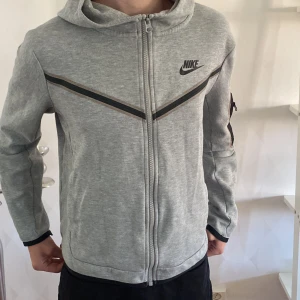 Nike tech fleece - Grå Nike tech fleece. Finns en fläck på den, se tredje bilden. Storlek 146/152 men kan även passa S