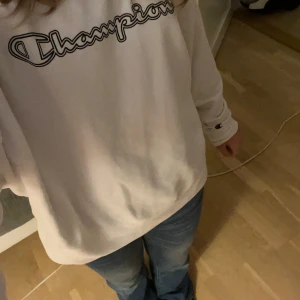 Vit tröja från Champion M - Säljer en vit sweatshirt från Champion i storlek medium. Den har en klassisk Champion-logga på bröstet och är superbekväm med långa ärmar. Perfekt för en avslappnad stil eller att mysa i hemma. ❤️