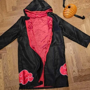 Akatsuki kappa  - Akatsuki kappa med luva utan mask. Bytt dragkedja till svart. Mjuk. Perfekt till alla tillfällen. Smal. St 36 till 38. Möts i Gbg. 260kr. Svart med röda moln. 