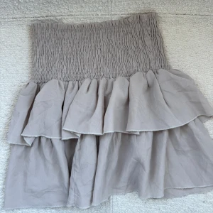 Beige volangkjol från Neo Noir - Snygg beige kjol från Neo Noir med volanger! Fint skick och är inte nopprig!❤️Pris kan diskuteras om försäljningen går fort!