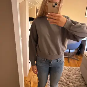 En mörkgrå sweatshirt i storlek xs från Gina tricot.  
