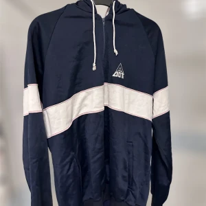 Träningshoodie - Blåvit träningshoodie som är tunn och skön att ha när man vill träna!! Den är från DOT och är i storlek L