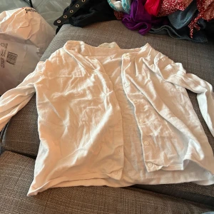 Vit långärmad skjorta från H&M - Säljer en vit långärmad kofta från H&M. kofta är i bomull och har knappar längs framsidan. Perfekt för både vardag och fest. Den är i bra skick och väldigt bekväm att ha på sig. Passar till många olika outfits!