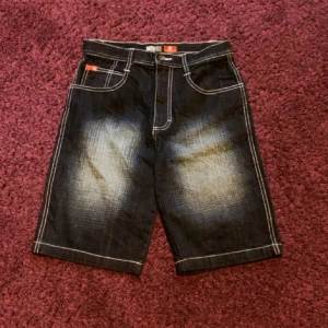 Riktigt feta southpole jorts - Sjukt snygga Southpole red tab jorts fett rare och i jättebra skick utan defekter.. Obs ser svarta ut men är mer ät marinblaa hället i verkligheten!! Mätt: Midja 37cm (rakt över) Längd 53cm !! PRIS KAN DISKUTERAS!!