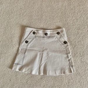 ZARA minikjol med sjömansknappar / ankare - Otroligt snygg minikjol i bomull med marinblå kontrastsömmar och guldiga knappar med ankare. Använd några gånger, i mycket bra skick.