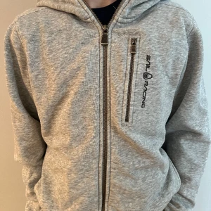 Sailracing bowman zip hoodie - Sailracing bowman zip hoodie från kidsbrandstore. Den är väldigt fin men sliten i armbågarna. Storlek 170. Nypris 1000 kr mitt pris 150kr.😁