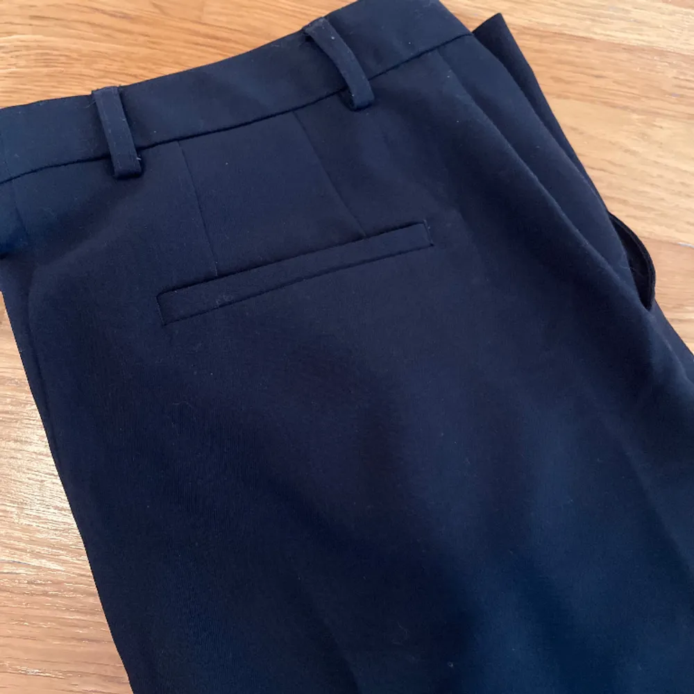 Fina svarta kostymbyxor. Regular high waist. Använda några gånger, är fortfarande i fint skick😊Finns fickor fram och en fake ficka bak! Innebenslängden är 69 cm.. Jeans & Byxor.