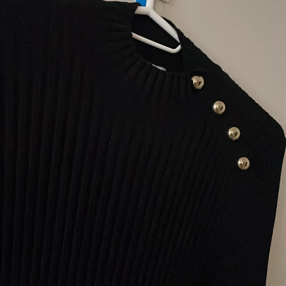 Ribbad svart tröja med guld detaljer/knappar på ena sidan. Från H&M i strlk XS.  . Tröjor & Koftor.