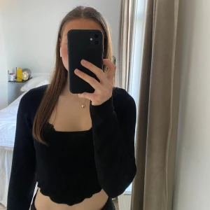 Svart tröja  - Svart tröja med lite glitter i och rundad hals.