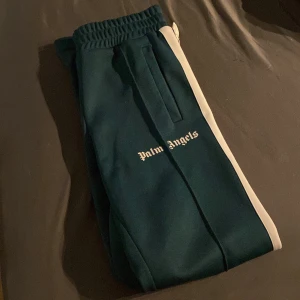 Palm angels byxor - Ett par mörk gröna palm angels byxor i storlek s 