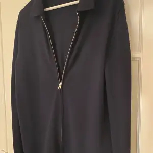 En mörkblå tunn, zip up tröja från J.Lindeberg Storlek M Nypris 1800kr 