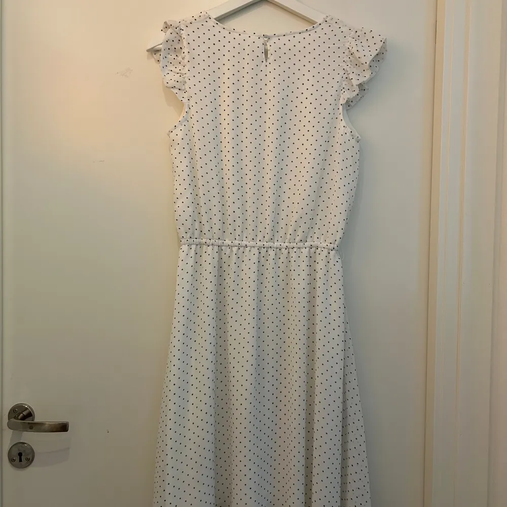 Vit klänning med grå prickar perfekt till skolavslutningen, kalas eller att ha i sommar. Klänningen är i mycket fint skick och är från Kappahl. Stl: 170 Barn men passar även XS vuxen.. Klänningar.