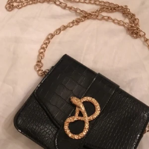 2 väskor - Den vita är fr new yorker Den svarta okänt var den kommer fr.kedja ingår ej