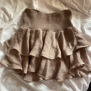 Volangkjol - Säljer denna Volangkjol i en beige-brun färg från shein! Den går att använda som topp också, tycker nästan att det är finare!