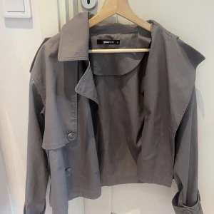 Grå trenchcoat  - En grå trenchcoat från Gina Tricot i storlek XS. Använd 2 gånger då jag sen köpte den i en annan färg. Tillkommer även ett skärp med jackan! 💕💕 nypris:699