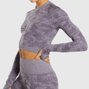 Gymshark Adapt Camo Seamless Violet Purple Long Sleeve Top S - Revinting because it doesn’t fit me. Previous owner removed the care instructions tags off. Some crackling in the logo print of the top. Gently used condition. No tears, rips, runs, holes, stains, fuzz, pilling. Not stretched out. No other flaws to n